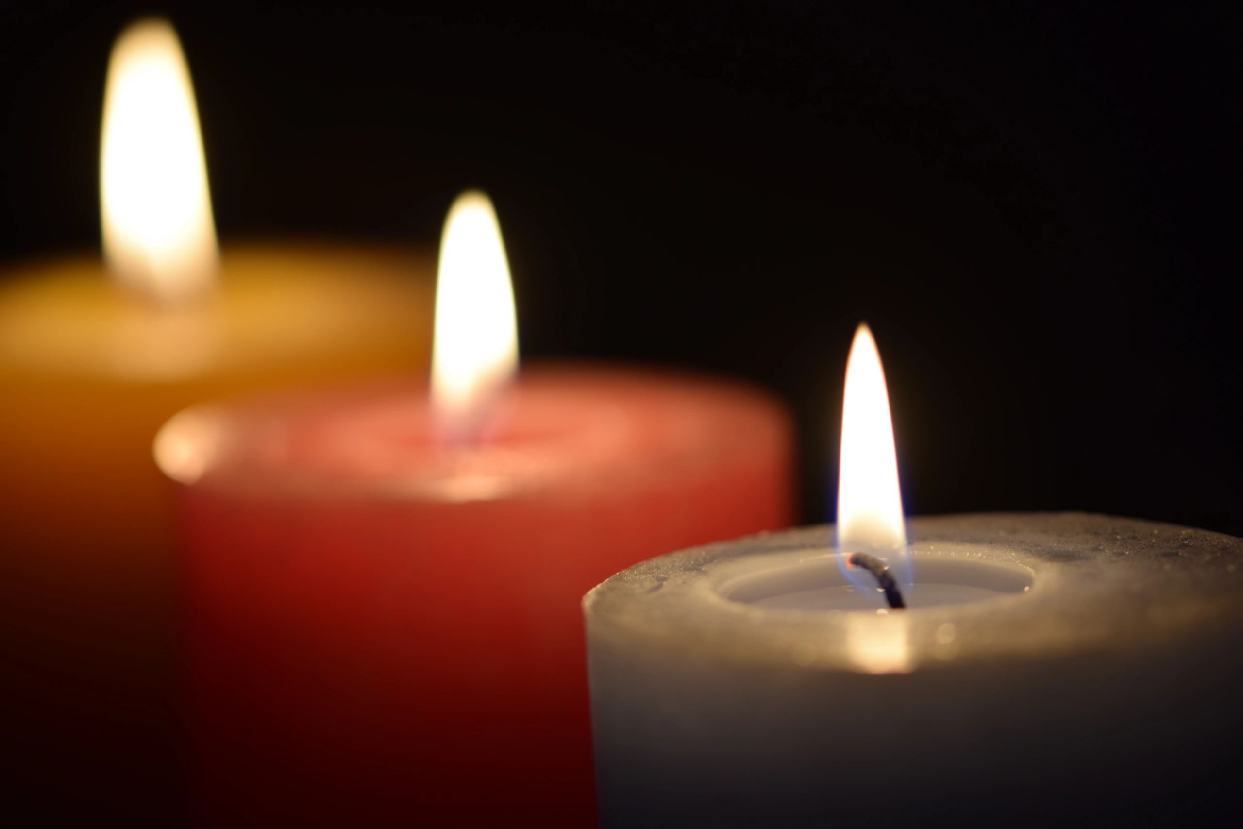 Prayer candles glowing in a quiet church setting